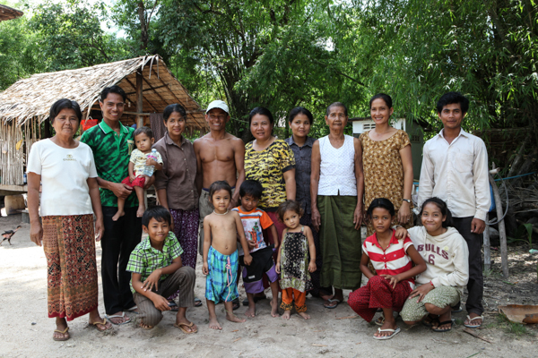 Marin (pictured second from left in the green shirt) with his family, some close village friends and students.